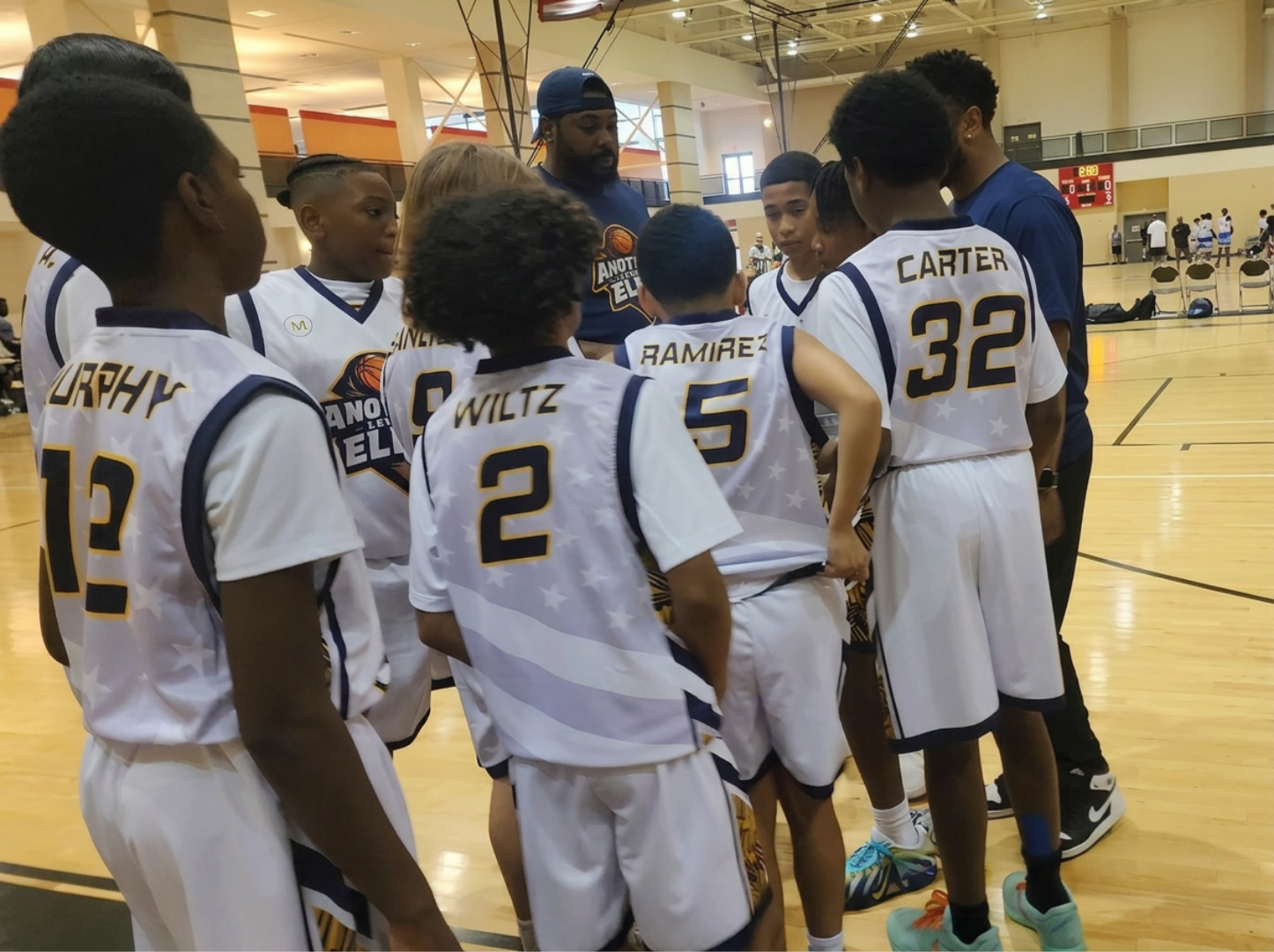ALE Lions players listening to their coaches in a team huddle
